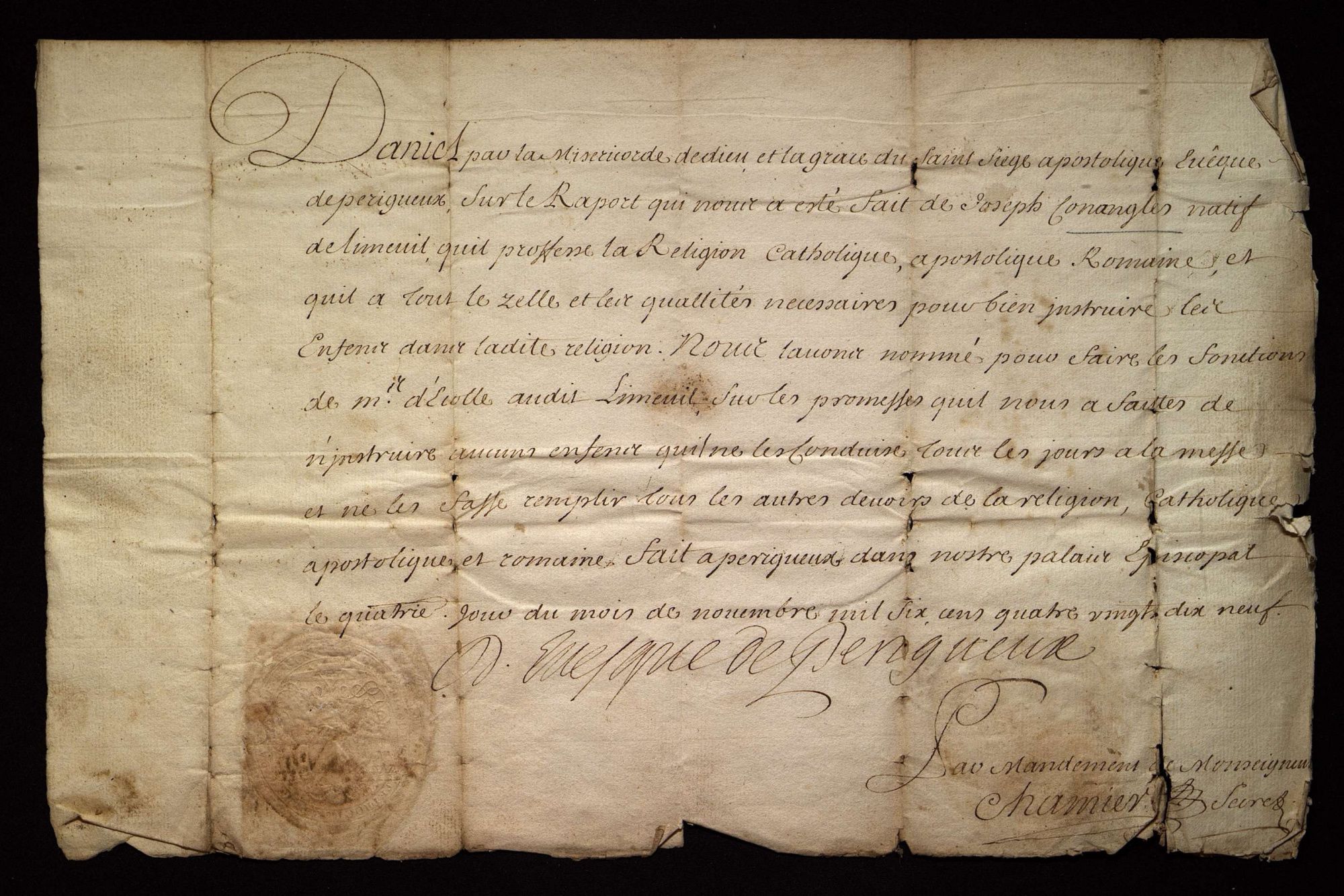 Famille Conangles, de Limeuil. Commission de maître d'école délivrée par l'évêque (1699).